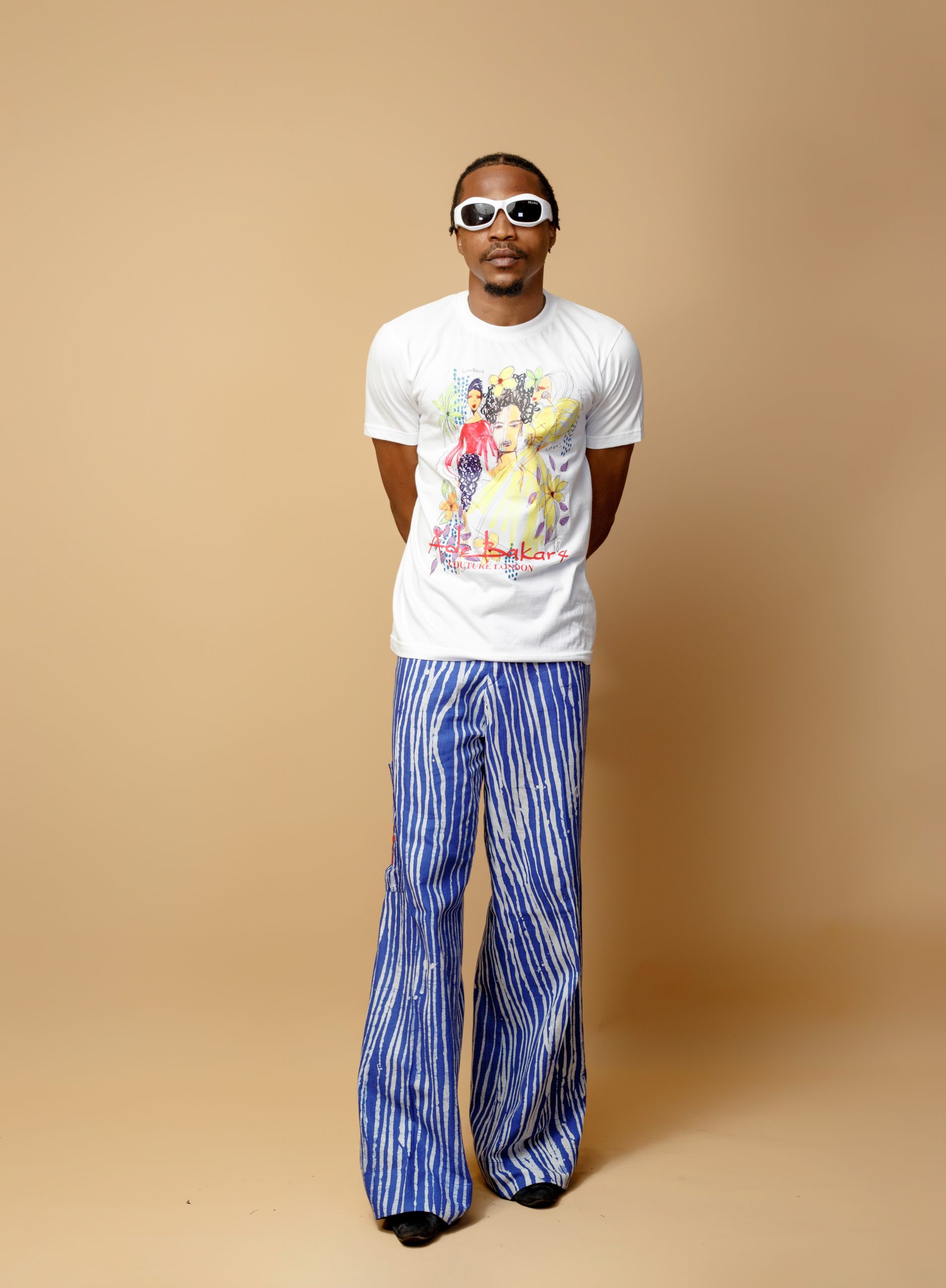 White T-shirt with fashion illustrations and Adire ila trousers